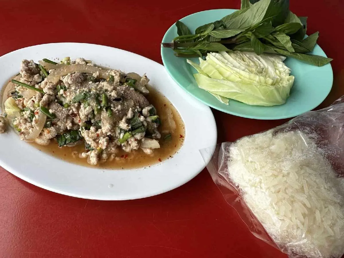 バンコクの釣具屋近くで最初に食べたタイ料理。タイ風肉野菜炒め定食。ご飯と生の野菜が付くが、タイ北東部料理らしくご飯は餅米だった。©望月俊典