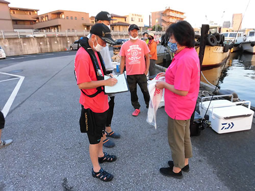 女将が乗船名簿とゴミ袋を配布